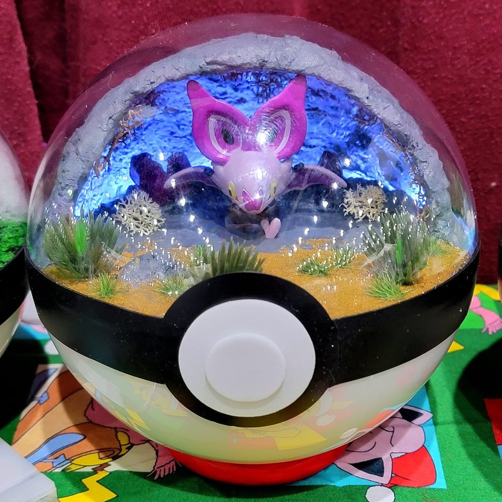Noibat

A Noibat is tucked into one of the maker's handmade miniature scenes. If the display starts making ultrasonic noises, I'm leaving.